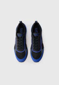 Black and blue athletic shoes featuring a mesh upper, lace closure, and a textured rubber sole with logo accents in blue.