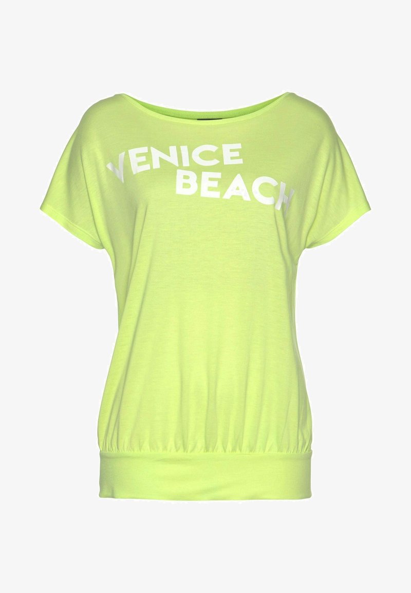 Světle zelený krátký rukáv top s volným střihem, který má na přední straně tučná bílá písmena "VENICE BEACH" a nařasený lem.