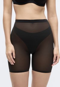 Calções curtos pretos transparentes de cintura alta com cintura lisa, textura semitransparente e design justo até à metade da coxa.