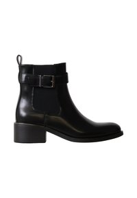 Bottine en cuir noir avec petit talon bloc, panneau élastique sur le côté, bride à boucle et languette à l’arrière.