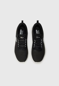 Pair of black Skechers sports shoes with white sole and laces, viewed from above on a plain light background.