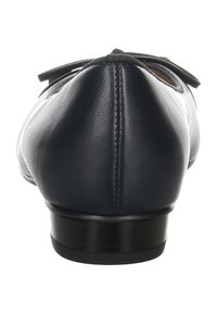 Ballerines en cuir marine avec un bout arrondi, un nœud proéminent à l'avant et un petit talon noir. Texture lisse et design épuré.