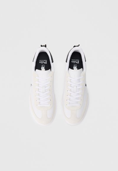 Sapatilhas Polo Ralph Lauren brancas e bege com aba traseira preta e logótipo na lateral, vistas de cima sobre um fundo claro.