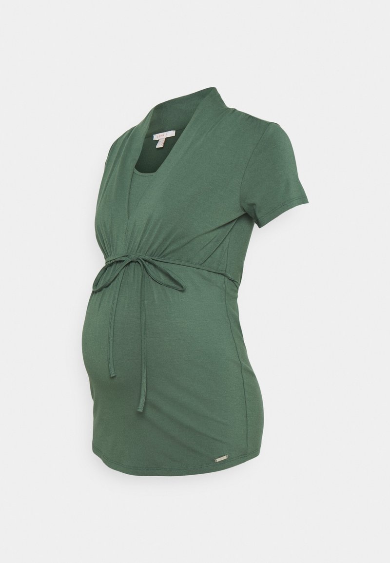 Maternity top in dark green, made of soft fabric. Features a wrap design with tie closure at the waist and short sleeves.