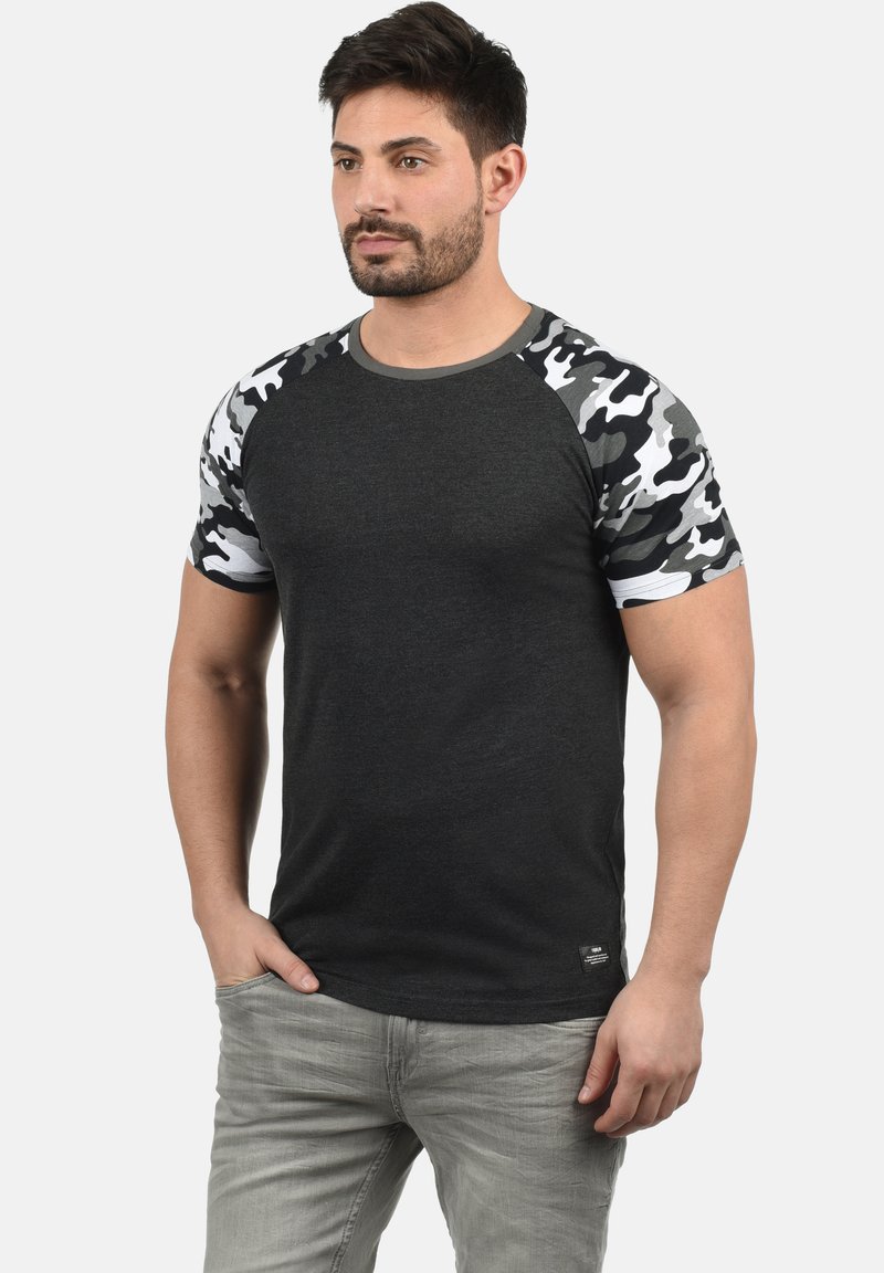 Black t-shirt with gray camo patterned short sleeves, crew neckline, and a smooth texture; features a small logo at the hem.
