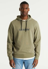 Olive green hoodie made of soft fabric, featuring a kangaroo pocket, drawstrings, and the word "CHASIN'" in bold black lettering.