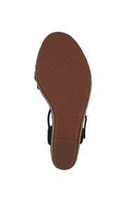 Suela de goma marrón con un patrón de diamante y un acabado similar al cuero. Marca "GANT" estampada en el lateral. Diseño ligero y flexible.