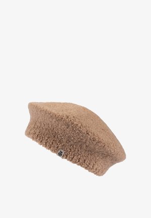 Beige textured wool beret with a small fabric logo tag on the brim, isolated on a white background.