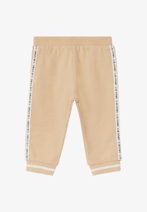Beige sweatpants with a soft texture, featuring white stripes on the sides with "CLUB CITENESS" text. Elastic waistband and cuffs.