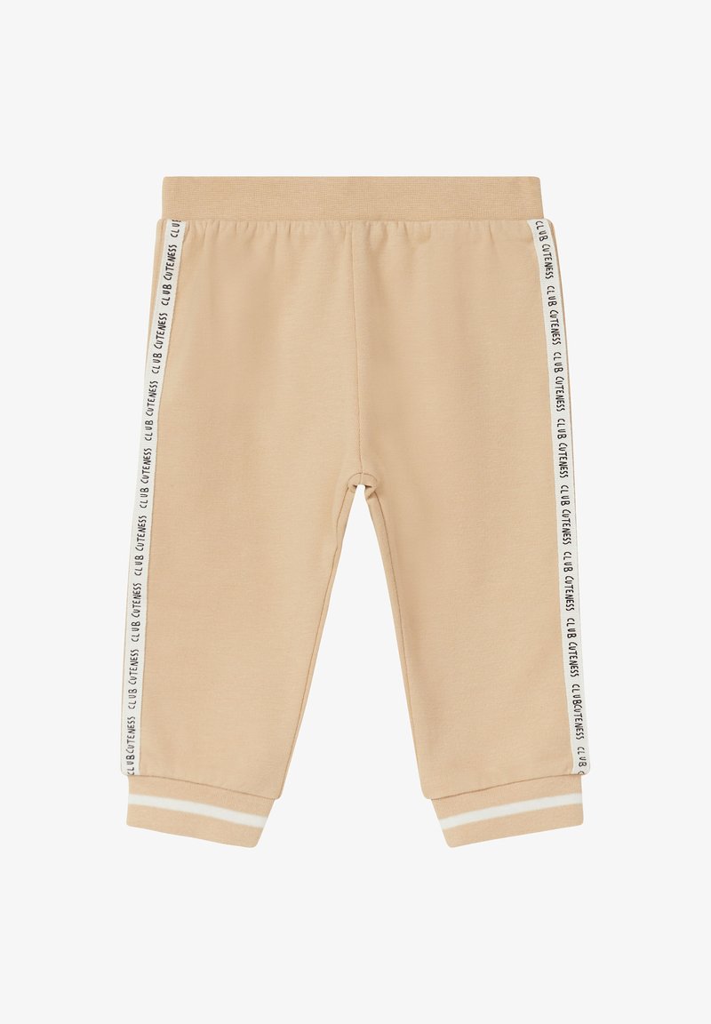 Beżowe dresy o miękkiej fakturze, z białymi paskami po bokach i napisem "CLUB CITENESS". Elastyczny pas i mankiety.