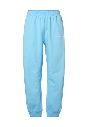 Světle modré tepláky s elastickým pasem a manžetami, s malým bílým logem "bruno banani" na horní levé stehně.