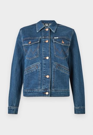 Blue denim jacket with copper buttons, two chest flap pockets with button closures, and two diagonal waist pockets.