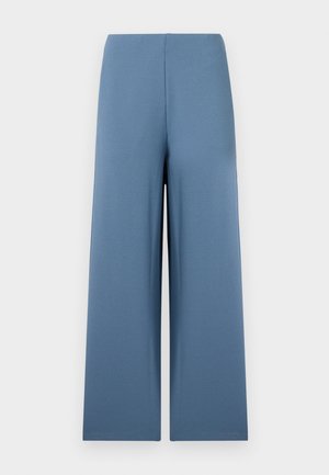 Weite Hosen aus weichem, blauem Stoff. Mit einem nahtlosen Bund und einer gleichmäßigen, glatten Textur. Keine sichtbaren Verschlüsse oder Taschen.