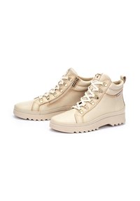 Beige leather high-top sneakers with a textured finish, featuring lace-up and zipper closure, and a ridged sole for traction.