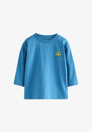 Modra bombažna majica z dolgimi rokavi in rebrastim ovratnikom, na prsih vezen zelen krokodil na rumenem otroškem avtomobilčku.