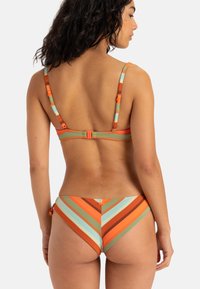 Gestreepte bikini in oranje, groen en blauwe kleuren; met verstelbare bandjes en een haaksluiting aan de achterkant. Bevat diagonale chevronpatronen.