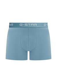 Sous-vêtements boxer bleu clair en tissu lisse. Dotés d'une ceinture élastique siglée G-Star et d'une forme avec poche de soutien.