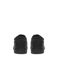 Black leather shoes with a smooth finish, featuring a rounded toe, low heel, and subtle stitching details. No visible hardware.