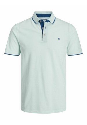 Lyseblå kortærmet polo med mørkeblå kant på krave og ærmer, tre-knaps placket samt lille broderet logo på brystet.