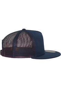 Casquette de camionneur bleu marine avec un devant uni et un arrière en maille. Elle possède une visière plate et une fermeture à pression ajustable.