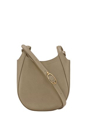 Taupe leather crossbody bag with curved shape and adjustable strap featuring a gold oval buckle.