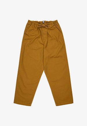 Pantalones de algodón beige con cintura elástica, cierre de cordón, dos bolsillos laterales y perneras ajustadas. Textura suave sin patrones visibles.