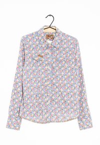 Camicia blu a maniche lunghe con motivo floreale, con chiusura a bottoni e due tasche sul petto. Il tessuto appare texturizzato con piccoli fiori colorati.
