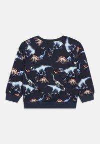 Μπλε ναυτικό φούτερ με εκτύπωση δεινοσαύρων σε πολλαπλά χρώματα. Κατασκευασμένο από απαλό ύφασμα με ριμπ μανσέτες και τελείωμα, παρουσιάζοντας διάφορα είδη δεινοσαύρων.