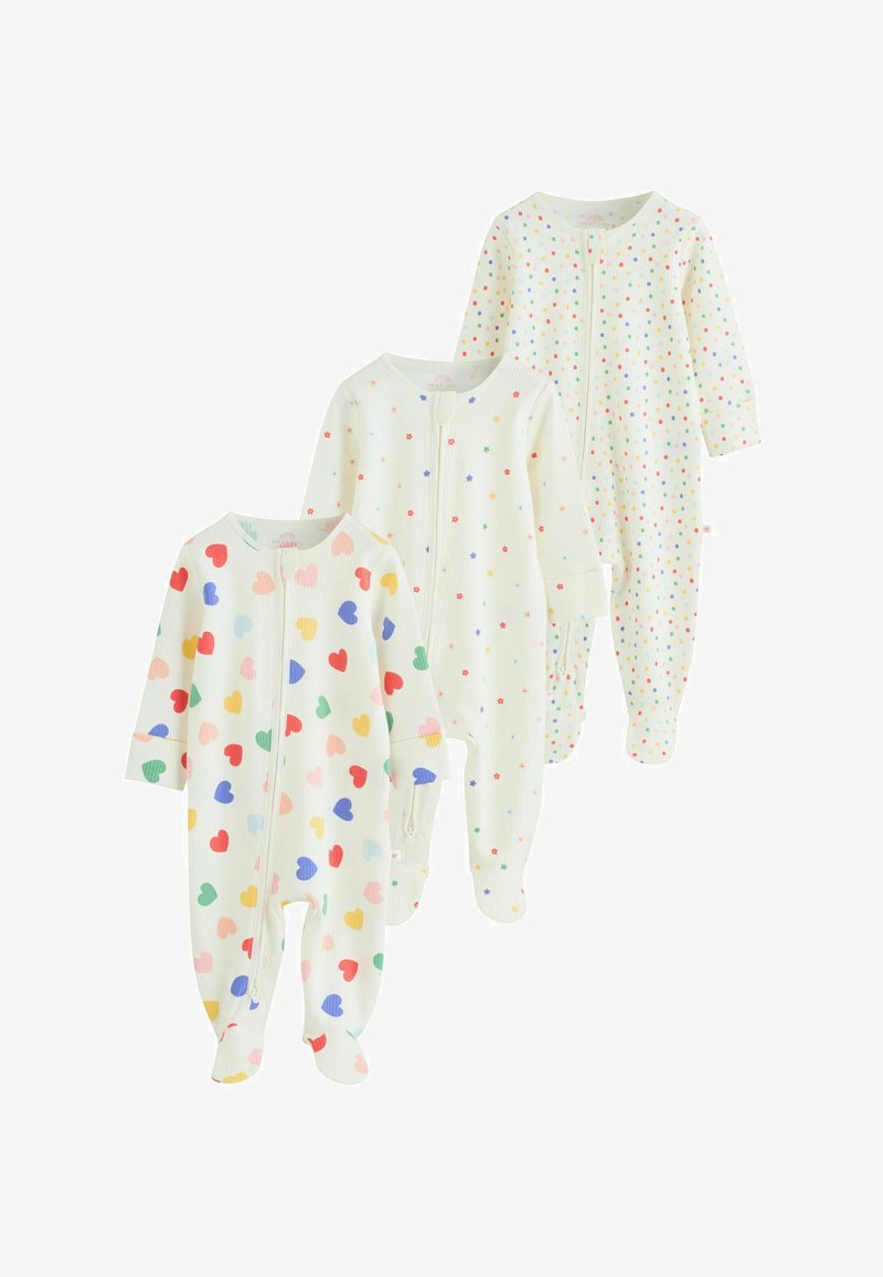 Trois pyjamas blancs pour bébé avec pieds intégrés, ornés de motifs colorés : cœurs, petites étoiles et pois multicolores, chacun avec une fermeture éclair à l'avant.