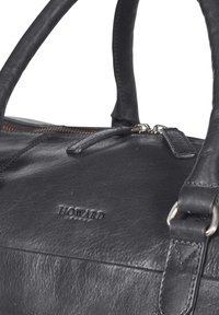 Black leather duffel bag with dual handles, zipper closure, embossed "HOWARD" logo, and smooth texture. Features silver-tone hardware accents.