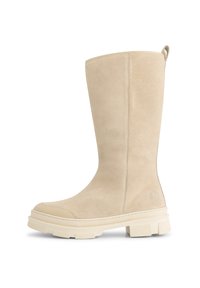 Beige suède enkellaarzen met een gladde afwerking, afgeronde neus en dikke rubberen zool met een gestructureerd profiel en een trekband aan de achterkant.