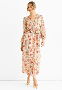 Floral wrap dress in light fabric with a V-neck, long puff sleeves, and a waist tie. Features a mix of red, blue, and yellow colors.