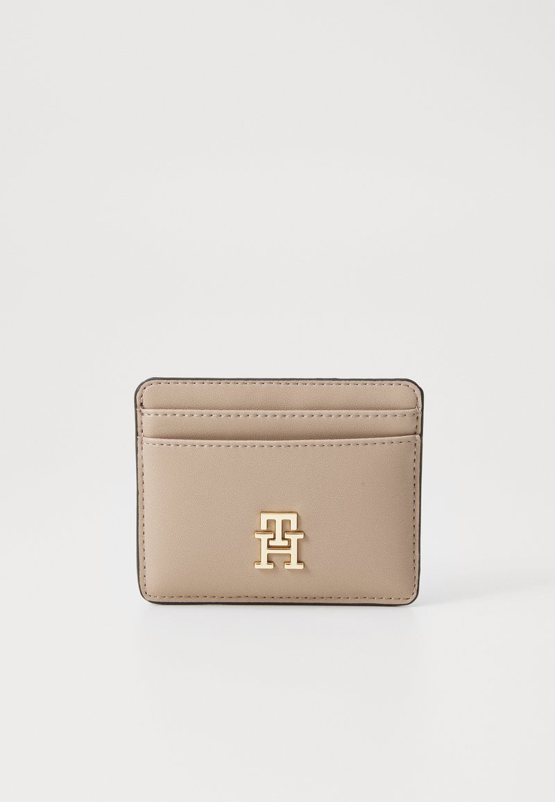Beige synthetic cardholder with gold-tone logo, featuring multiple card slots and a sleek, minimalist design. Edges are stitched.