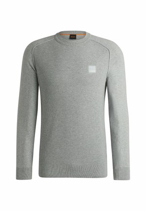 Light grey long-sleeve knitted sweater with a ribbed texture, round neck, and a small square logo patch on the left chest.