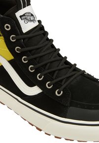 Black suede high-top sneaker with yellow accents, featuring round black laces, white side stripe, rubber sole, and Vans logo patch.