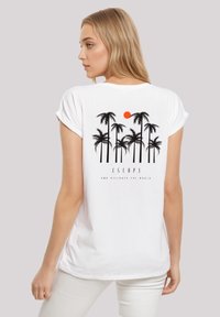 White cotton t-shirt with short sleeves, featuring black palm tree graphic and orange sun on the back, "ESCAPE" text below.