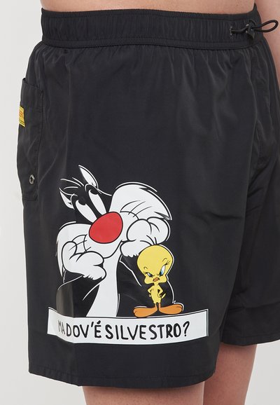 Pantaloni da bagno neri realizzati in materiale leggero con una grafica di Sylvester il Gatto e Titti, con una casella di testo bianca sottostante.