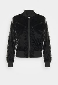 Black bomber jacket with a glossy finish, zip-front closure, ribbed cuffs, and decorative stitching on sleeves. Features two zippered pockets.