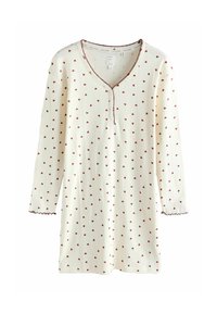 Kudotunnyt yö-tunika kermansävyssä, jossa on punaisia sydänkuvioita ja V-pääntie koristeompeleilla. Pitkät hihat, joissa on aaltoilevat reunat.