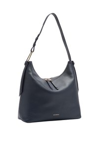 Granatowa skórzana torba na ramię o zaokrąglonym kształcie, z elementami z pozłacanego metalu, dwiema sznurków do ściągania oraz subtelnym logo. Miękka faktura i swobodny kształt.