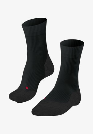 Calcetines negros acanalados con punta y talón reforzados, que presentan un pequeño logo rojo. El diseño se centra en la durabilidad y la comodidad.