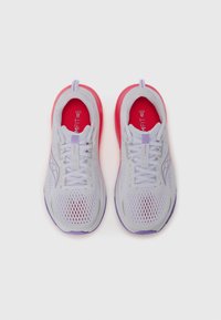 Leichte Sportschuhe in Grau mit Netzgewebe. Ausgestattet mit einer pinken und lilanen Sohle, kontrastierenden Schnürsenkeln und einer gepolsterten Innensohle mit Branding.