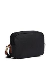 Black rectangular crossbody bag made of durable fabric, featuring a gold zipper, brown leather accents, and a detachable shoulder strap.