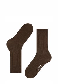 Brune bomuldsstrømper med ribbet design, der har en polstret sål og glat overflade. Viser logo i hvidt på bunden.