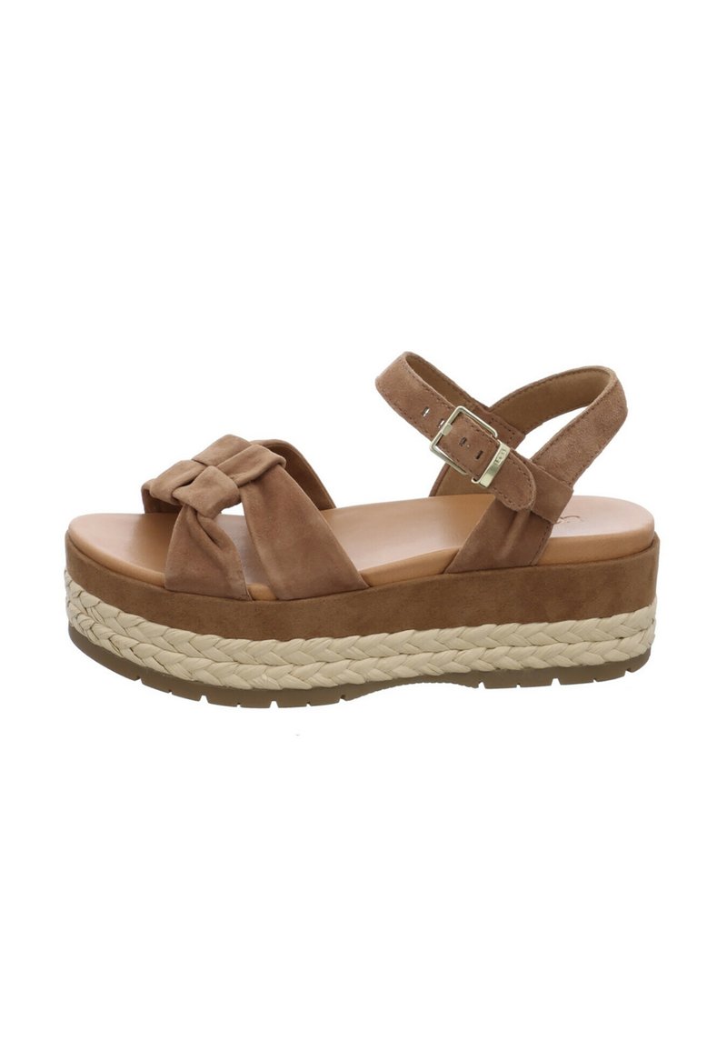 Brown suede platform sandals with woven jute midsole, adjustable ankle strap, and knotted front design. Smooth outsole for traction.