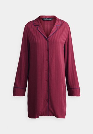 Maroon button-up shirt made of smooth fabric, featuring long sleeves, a collar, and blue piping along the edges and buttons. Vertical stripes visible.