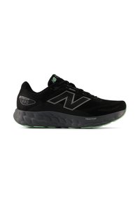 Zwarte hardloopschoenen met een ademende mesh bovenkant, grijze accenten en een groene rubberen zool met een dikke, gevoerde tussenzool.