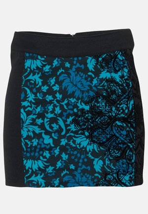 Black and blue floral skirt featuring a textured design with vibrant turquoise flowers and intricate black patterns on one side.