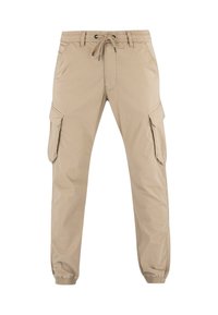 Pantalones cargo beige con cintura elástica y cordón, bolsillos laterales con solapa y puños elásticos en los tobillos.