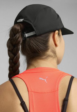 Black cap with a textured surface and adjustable strap, worn above an orange mesh tank top with a small silver Puma logo on the back.